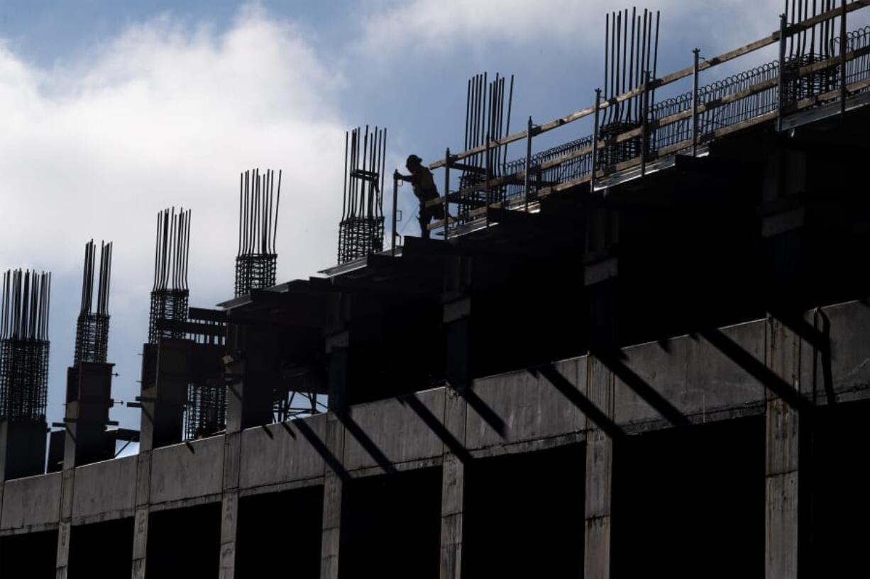 A construction worker moves along the top of the ilani parking garage Monday. The structure is expected to be completed in late summer or fall.