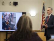 The image of victim Hartley Anderson, 5, left, is displayed for the jury as Senior Deputy Prosecutor James Smith gives his opening statement Tuesday in the murder trial of Ryan M. Burge in Clark County Superior Court. He stands accused of killing his then-girlfriend&#039;s daughter.