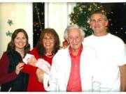 Paisley DeKalb, one month, is held by her great-grandmother, Pat Crawford, 71, at a holiday gathering at her home in the Image neighborhood, Vancouver.