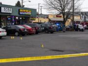 Vancouver police investigate a fatal shooting at Stapleton Road and Fourth Plain Boulevard in central Vancouver on Feb. 4, 2020. A young man was shot and killed outside Boba Tree and Quick Stop Smoke Shop.