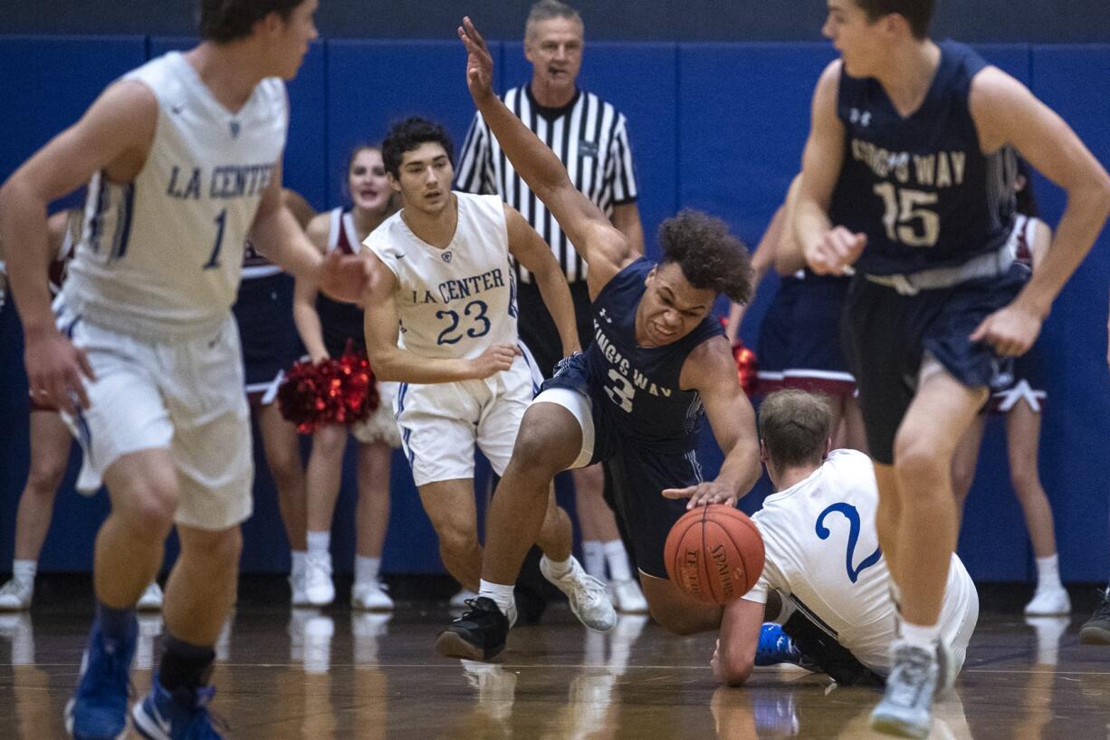 King’s Way’s Kobi Cason trips while dribbling up the court during a game against La Center at La Center High School on Thursday night, Feb. 6, 2020.