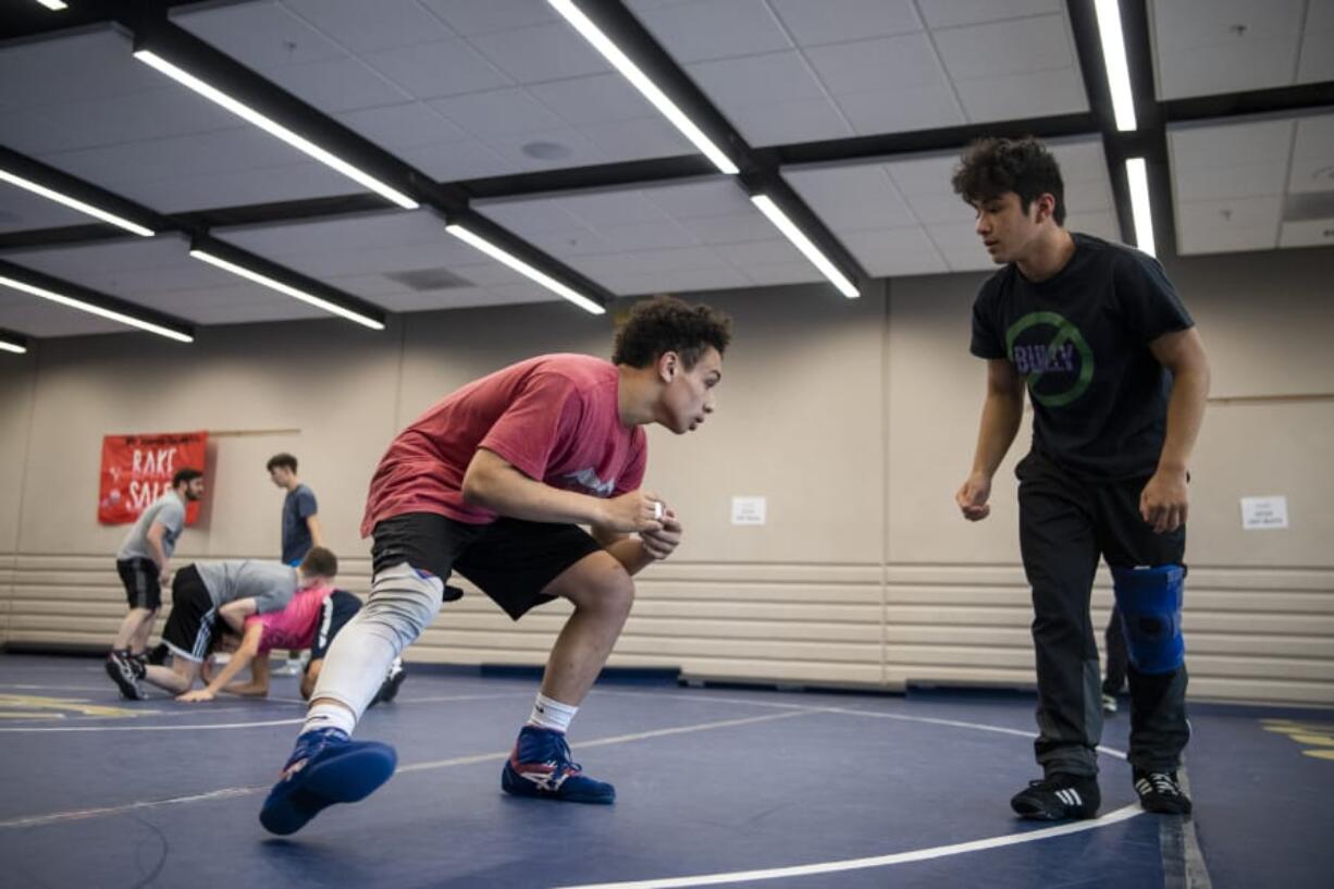 Seton Catholic sophomore wrestler CJ Hamblin, left, drills with junior Elijah Volk during practice in Vancouver on Feb. 11, 2020.