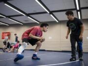 Seton Catholic sophomore wrestler CJ Hamblin, left, drills with junior Elijah Volk during practice in Vancouver on Feb. 11, 2020.