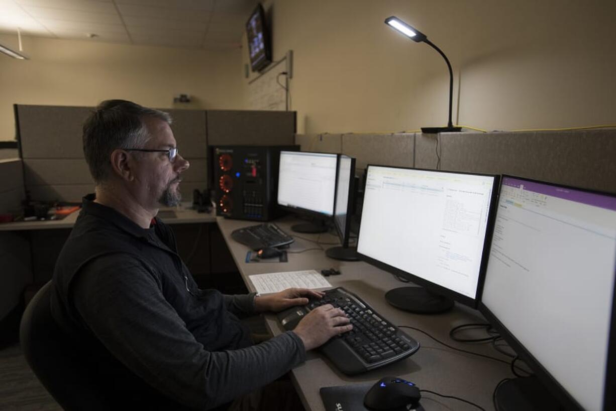 Digital forensics investigator Christopher Prothero works on a computer during an investigation in the Digital Evidence Cybercrime Unit at Vancouver Police West Precinct.