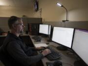 Digital forensics investigator Christopher Prothero works on a computer during an investigation in the Digital Evidence Cybercrime Unit at Vancouver Police West Precinct.