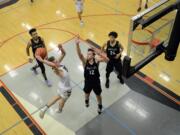 Union senior Tanner Toolson dunks over Kentlake sophomore Colin Eversole at Union High School on Tuesday, January 21, 2020.