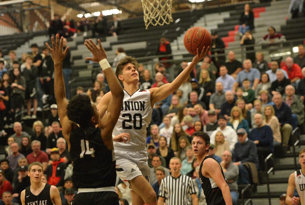 Union senior Josh Reznick lays up the ball past Kentlake senior Jaleel Walton at Union High School on Tuesday, January 21, 2020.