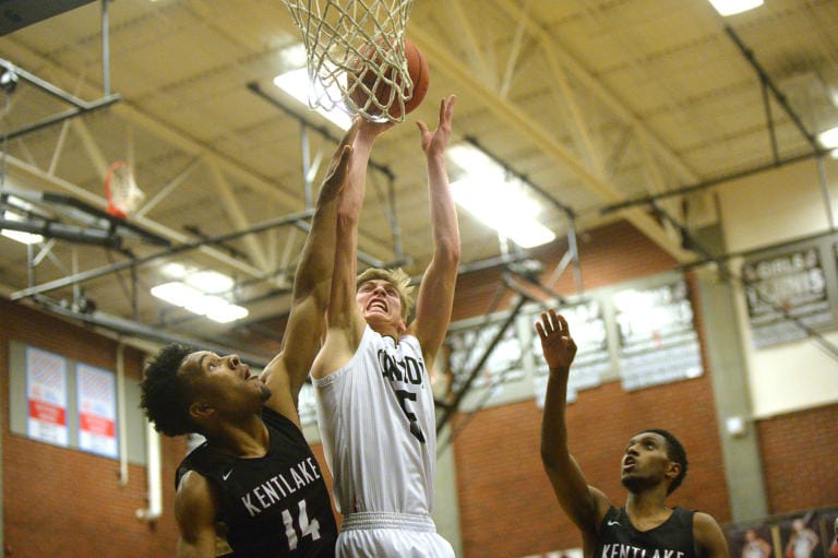 Union senior Tanner Toolson shoots with pressure from Kentlake senior Jaleel Walton at Union High School on Tuesday, January 21, 2020.