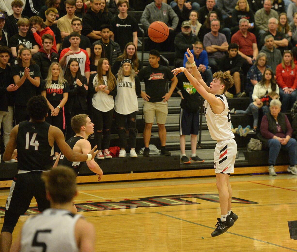 Union junior Kaden Horn shoots a deep three pointer against Kentlake at Union High School on Tuesday, January 21, 2020.