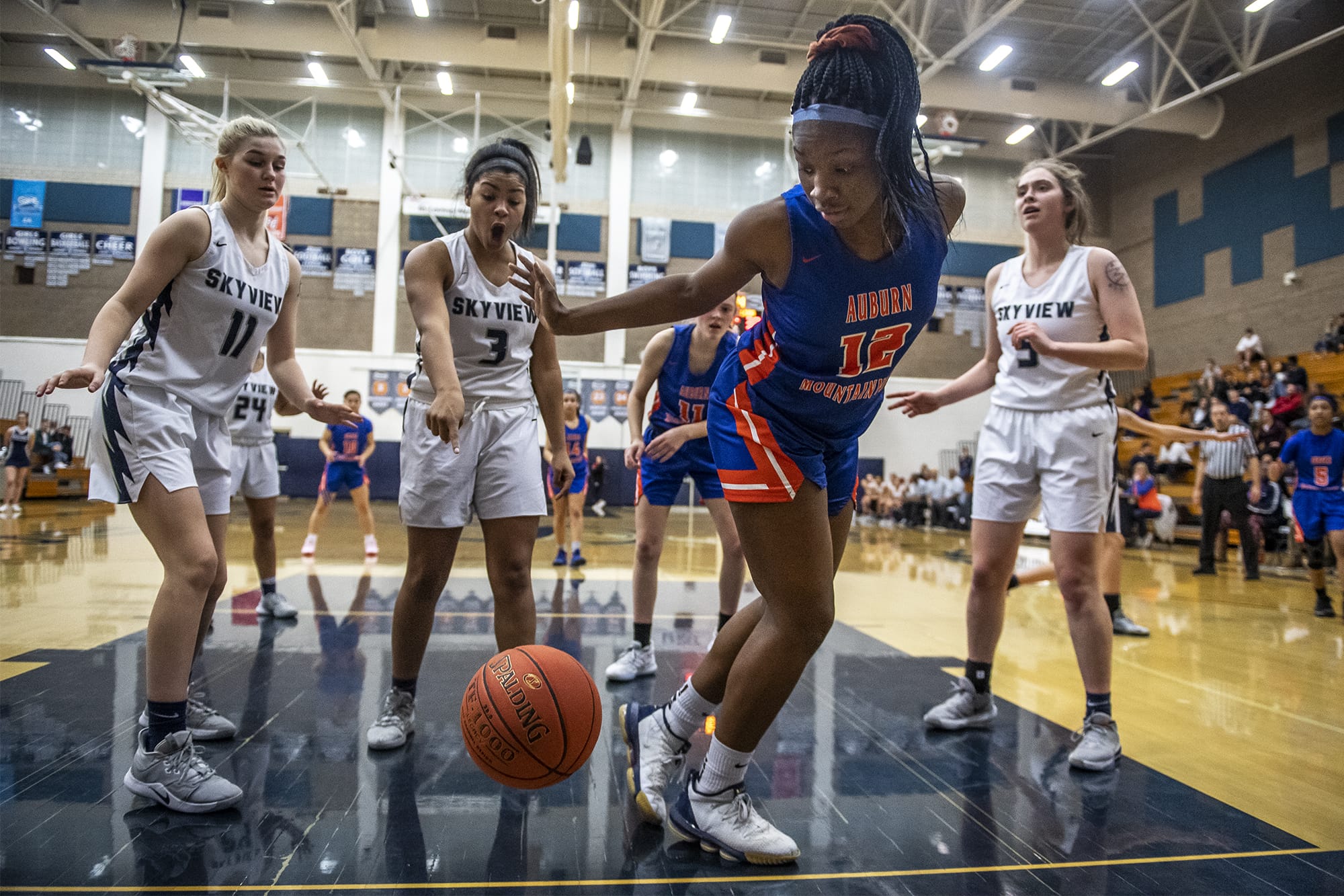 Skyview’s Mikelle Anthony, center left, reacts to Auburn’s Azaria Johnson’s efforts to keep the ball in bounds during a game at Skyview High School on Thursday night, Feb. 13, 2020.