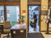 Mark Traxler carries his belongings out the front door after eating a meal at the Washougal Community Center.