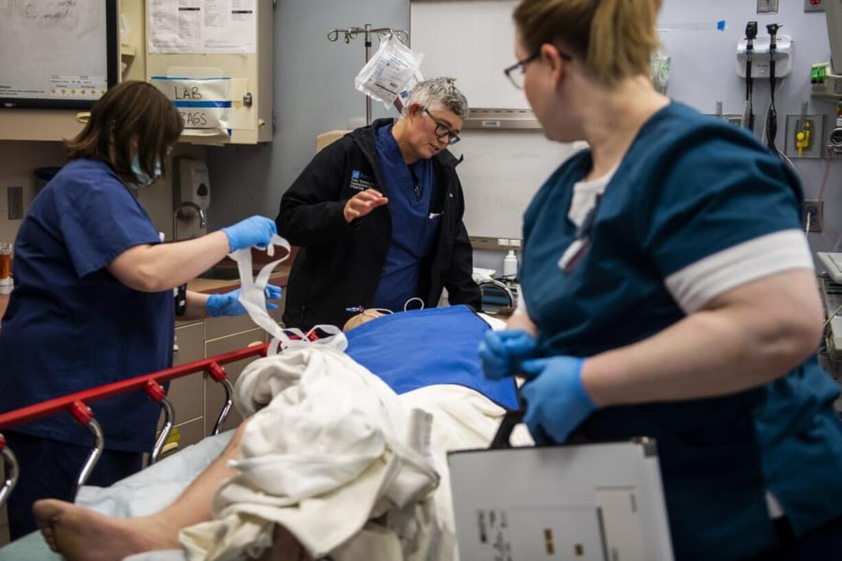 Trauma surgeon Dr. Tracy Timmons, center, updates a patient on his injuries at PeaceHealth Southwest Medical Center in Vancouver. Timmons previously worked in trauma in Baltimore, where she had much less time to spend with patients, because of how busy her schedule was.