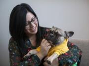 Erica London is a third-generation Latina born in the United States. Her therapy business is one of a handful of businesses in Clark County owned by a woman and a minority. Her French bulldog, Courage, accompanies her to work. &quot;Clients love him,&quot; she said.