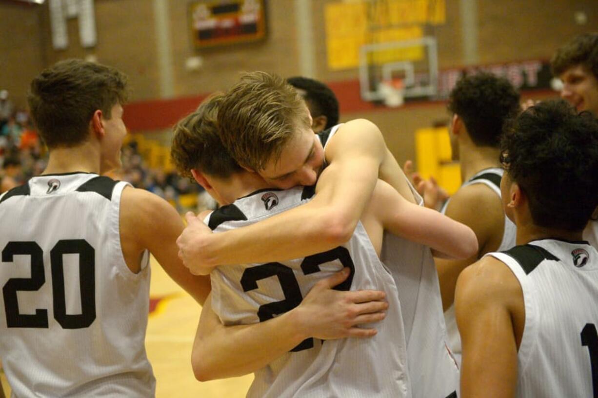 Union senior Tanner Toolson hugs teammate Kaden Horn after the 4A bi-district boys basketball championship game against Battle Ground at Prairie High School on Saturday, February 22, 2020. Union beat Battle Ground 82-57.