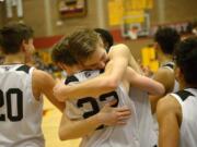 Union senior Tanner Toolson hugs teammate Kaden Horn after the 4A bi-district boys basketball championship game against Battle Ground at Prairie High School on Saturday, February 22, 2020. Union beat Battle Ground 82-57.