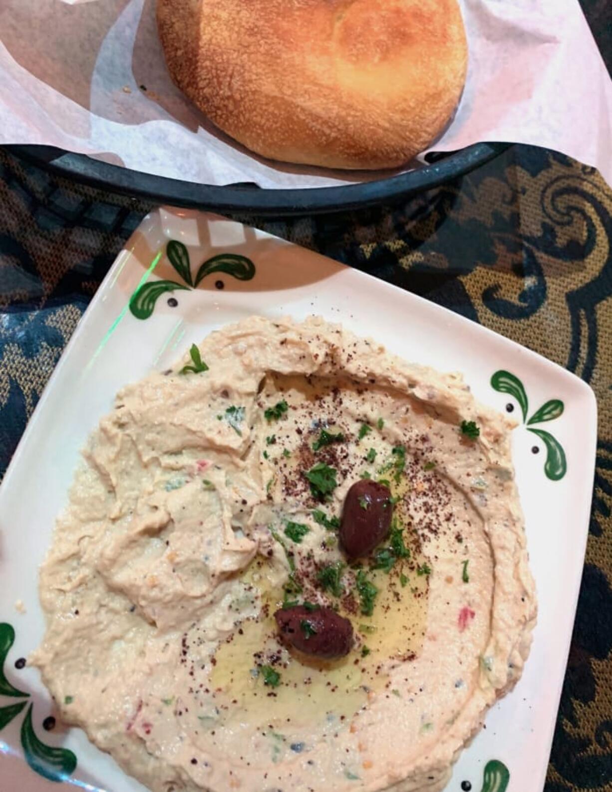 Pita with hummus, which is garnished with sumac and olive oil, at Petra House in Vancouver.