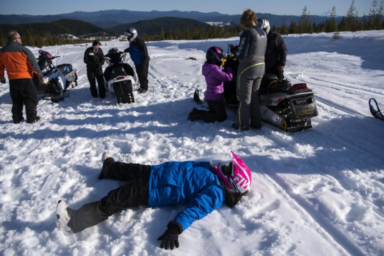 Washington State School for the Blind eighth-grader Angie Rodriguez makes a snow angel as the group takes a break from snowmobiling at Marble Mountain Sno-Park near Mount Saint Helens on Feb. 27, 2020.