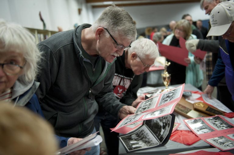 John Robinson, center, finds himself in a school yearbook photo from 1969, when he was in the eighth grade at McLoughlin Middle School. Hundreds of former students and faculty gathered at McLoughlin Middle School and George C. Marshall Elementary School on Saturday to share memories and bid the buildings farewell. The school buildings are slated to be torn down and replaced later this year.