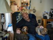 Bill Hoover sits with his dogs Daisey, left, Gotcha, right, and his friend&#039;s dog Pozey, back, at his apartment in Vancouver. Hoover&#039;s dogs love to sit on his lap while he&#039;s in his recliner.