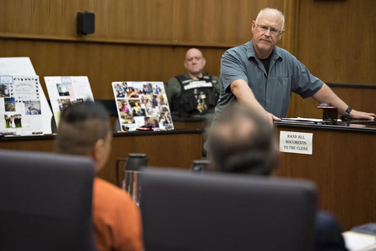 Jerry Romano, facing, father of murder victim Ariel Romano, speaks directly to defendant Jonathan &quot;Jon Jon&quot; Oson, in orange, while giving his victim impact statement before sentencing Thursday in Clark County Superior Court.