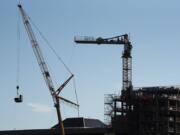 Crews work to disassemble a tower crane at the construction site for Kirkland Tower and Hotel Indigo on Thursday afternoon.