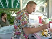 Skip Ballweber, founder and longtime owner of the Wiener Wagon, prepares a hot dog in 2001. Ballweber recently passed away, leaving behind a decadeslong legacy in the Vancouver community.