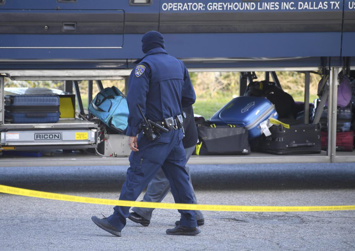 Investigators are seen outside of a Greyhound bus after a passenger was killed on board on Monday, Feb. 3, 2020 in Lebec, Calif. A gunman killed one passenger and wounded multiple others on a Greyhound bus traveling from Los Angeles to the San Francisco Bay Area early Monday morning, the California Highway Patrol said.