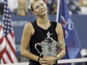 Maria Sharapova looks up to the crowd after winning the 2006 U.S. Open women's singles championship. Sharapova is retiring from professional tennis at the age of 32 after five Grand Slam titles. She has been dealing with shoulder problems for years.