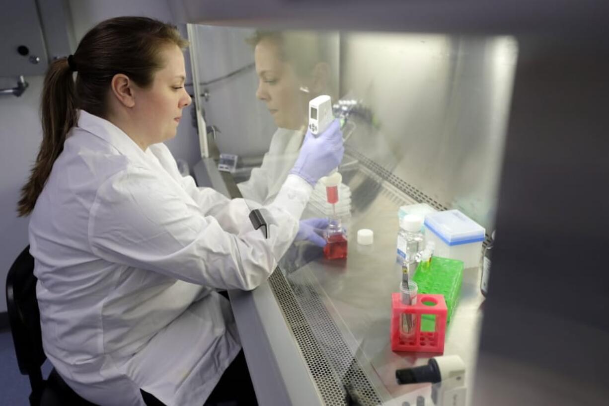 In this Wednesday, Jan. 15, 2020, photo scientist and study director Jennifer Molignano uses an electronic pipette to prepare culture medium, a dark pink fluid that provides nutrition to living human skin tissue, as she sets up a demonstration of experiments at a MatTek Corporation lab, in Ashland, Mass. Molignano demonstrated experiments created to evaluate the effects of exposing living human skin tissues to commercially available skin care products, as well as an experiment to evaluate the effects of ultraviolet B rays, a simulation of exposing skin tissues to sunlight.