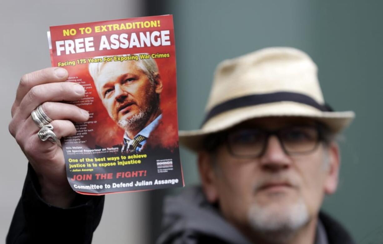 A demonstrator holds up a &quot;Free Assange&quot; leaflet outside Westminster Magistrates Court on Wednesday in London.