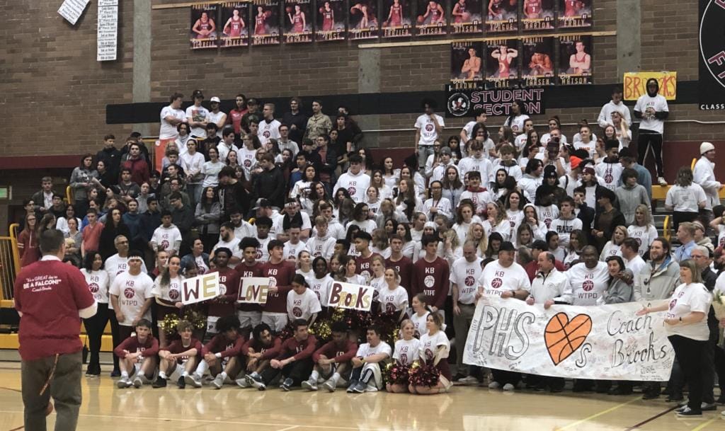 Before a bi-district basketball game Thursday, Prairie students, coaches and basketball players take a group photo to send to 20-year coach Kyle Brooks, who has been hospitalized with Guillain-Barre syndrome since Jan. 3.