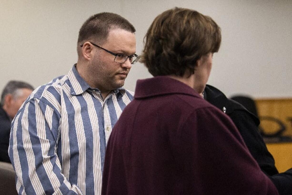 Ryan M. Burge, right, who stood accused of killing his then-girlfriend's 5-year-old daughter, Hartley Anderson, enters the courtroom for the verdict at Clark County Superior Court in Vancouver on Thursday. The jury convicted Burge of second-degree murder but was undecided on a charge of first-degree murder.