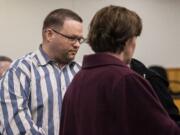 Ryan M. Burge, right, who stood accused of killing his then-girlfriend's 5-year-old daughter, Hartley Anderson, enters the courtroom for the verdict at Clark County Superior Court in Vancouver on Thursday. The jury convicted Burge of second-degree murder but was undecided on a charge of first-degree murder.