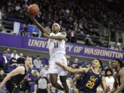 Washington guard Nahziah Carter (11) shoots above California guard Matt Bradley (20) during the first half of an NCAA college basketball game Saturday, Feb. 22, 2020, in Seattle. (AP Photo/Ted S.