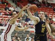 Washington State forward Tony Miller, left, and California forward Grant Anticevich go after a rebound during the first half of an NCAA college basketball game in Pullman, Wash., Wednesday, Feb. 19, 2020.