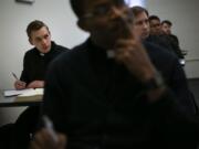 Seminarian Daniel Rice, left, sits with classmates during a lesson Feb. 5 on the Gospel of Luke at St. Charles Borromeo Seminary in Wynnewood, Pa. Future Catholic priests remain unflinchingly optimistic despite scandals that have driven faithful from the pews.