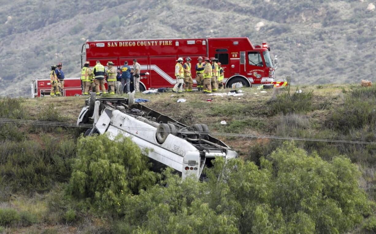 A bus rests on its roof after rolling down an embankment Saturday on State Route 76 in North San Diego County. Three people were killed.