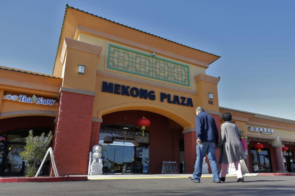 In this Feb. 13, 2020, photo, patrons enter Mekong Plaza in the Asian district, in Mesa, Ariz. Arizona&#039;s freshly crowned Asian District was deep into organizing its night market when news broke that a case of the illness known as COVID-19 was confirmed at nearby Arizona State University. Xenophobic comments on social media and phone calls started almost immediately, according to Arizona Asian Chamber of Commerce CEO Vicente Reid.