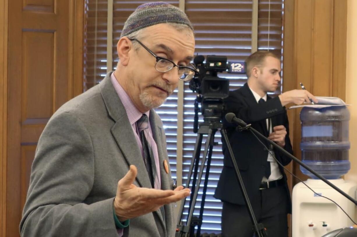 In this Wednesday, Feb. 19, 2020 photo, Rabbi Moti Rieber, executive director of the Kansas Interfaith Alliance, testifies against a bill to bar cities and counties from banning single-use plastic bags and straws, at the Statehouse in Topeka, Kan. Rieber says he&#039;s frustrated that lawmakers are considering such a measure and not having a meaningful conversation about climate change.