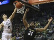 Oregon&#039;s Will Richardson, left, and Colorado&#039;s Evan Battey, center, go up for a rebound during the second half of an NCAA college basketball game in Eugene, Ore., Thursday, Feb. 13, 2020.