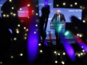 FILE - In this Sunday, Nov. 17, 2019 file photo, Democratic presidential candidate Sen. Bernie Sanders, I-Vt., speaks as supporters wave lighted signs during a fundraiser for the Nevada Democratic Party in Las Vegas. During the 2020 campaign, Sanders, who&#039;s known more for eschewing organized religion than embracing his Jewishness, has shifted the way he talks about his faith and tied it to his broader worldview.