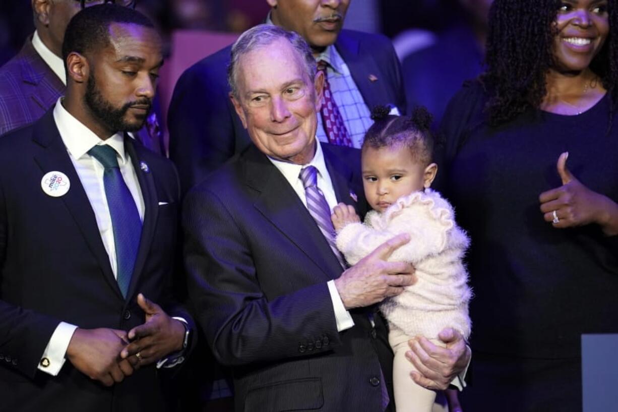 Democratic presidential candidate Michael Bloomberg is joined onstage by supporters Thursday during his campaign launch of &quot;Mike for Black America&quot; in Houston. (David J.