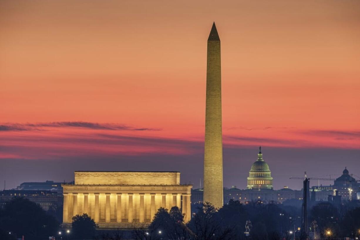 FILE - In this Feb. 17, 2020, file photo, the Lincoln Memorial, left, and the Washington Monument, center, are seen in the early morning light in Washington. The U.S. Capitol building is in the background right. For a majority of Democratic voters, going back to the days before Donald Trump isn&#039;t good enough. (AP Photo/J.