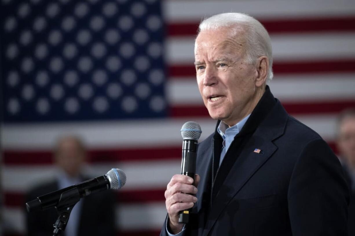 Democratic presidential candidate former Vice President Joe Biden speaks with Jill Biden at a caucus night campaign rally on Monday, Feb. 3, 2020, in Des Moines, Iowa.