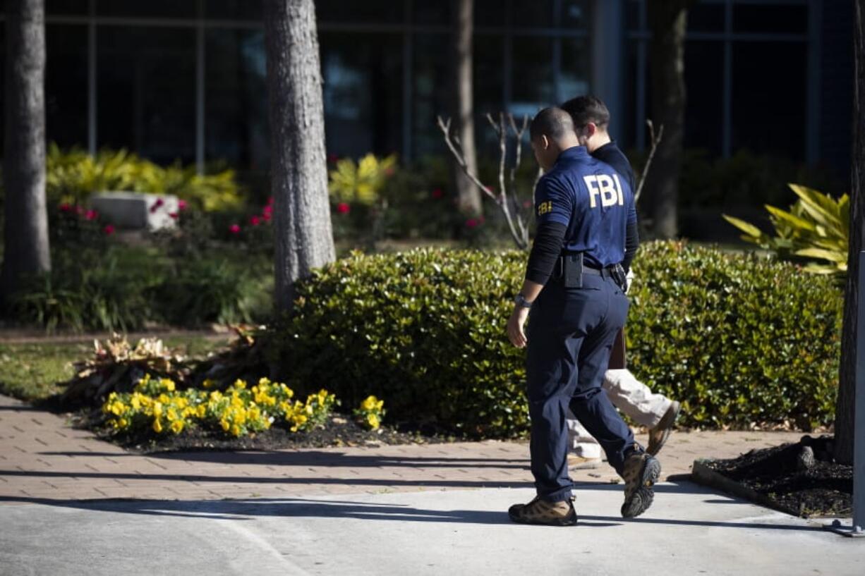 Authorities enter the Houston Independent School District Administration Building on Thursday, Feb. 27, 2020, in Houston.  Agents arrived at the school offices at around 8 a.m. for what FBI spokeswoman CJ Jones would only describe as a &quot;court-authorized law enforcement activity.&quot;  (Marie D.