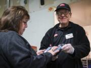 This Oct. 20, 2019 photo released by  412 Food Rescue shows a volunteer using the Food Rescue Hero app to check in at a Pittsburgh grocery store to pick up donated food. While millions of people struggle with food insecurity and hunger nationwide, the USDA estimates that more than 30% of the food in America is wasted each year.