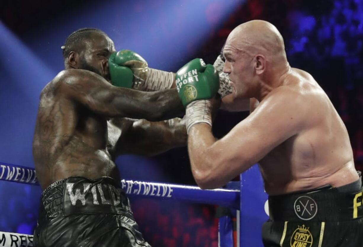 Tyson Fury, of England, lands a right to Deontay Wilder during a WBC heavyweight championship boxing match Saturday, Feb. 22, 2020, in Las Vegas.