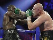 Tyson Fury, of England, lands a right to Deontay Wilder during a WBC heavyweight championship boxing match Saturday, Feb. 22, 2020, in Las Vegas.