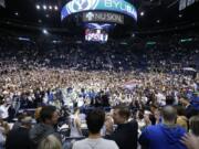 BYU students and fans celebrate on the court following BYU&#039;s 91-78 victory over Gonzaga in an NCAA college basketball game Saturday, Feb. 22, 2020, in Provo, Utah.