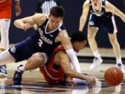 Gonzaga forward Filip Petrusev (3) collides with Pepperdine guard Keith Smith (11) during the first half of an NCAA college basketball game Saturday, Feb. 15, 2020, in Malibu, Calif. (AP Photo/Ringo H.W.